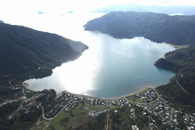 Aerial view of Ōkiwi Bay Holiday Park & Lodge on Croisilles Harbour, French Pass